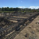 Residential construction site with steel reinforcement for foundation.